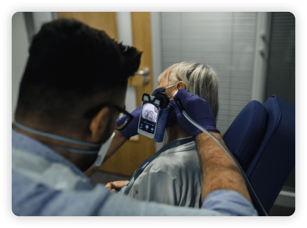 Audiologist checking hearing of a patient