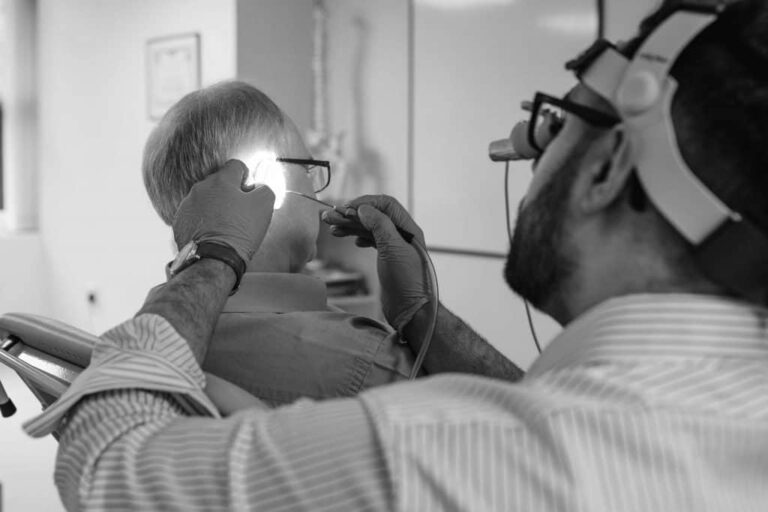 Man looking into patients ear