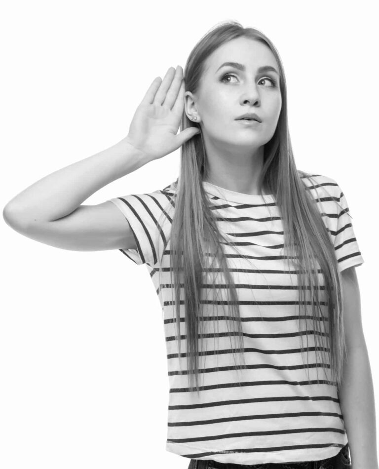 Woman holding hand over ear