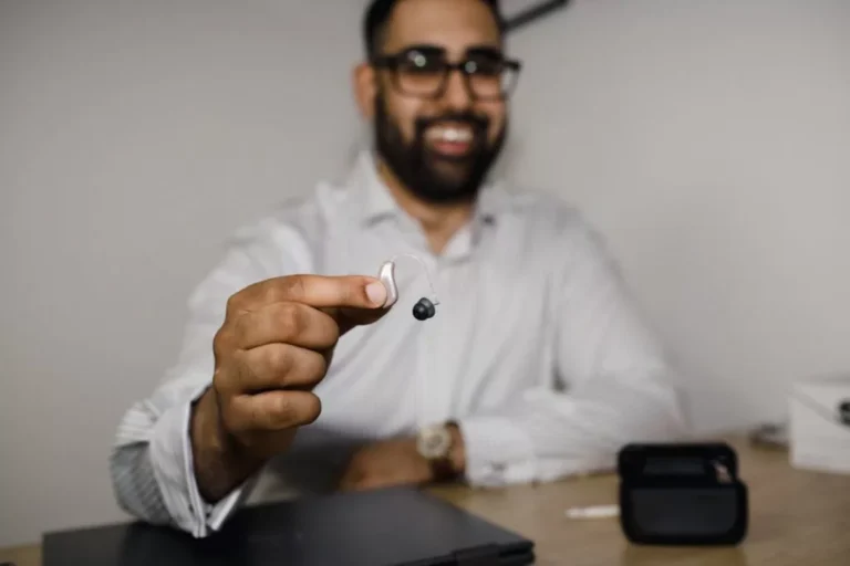 Man Holding Hearing Aid