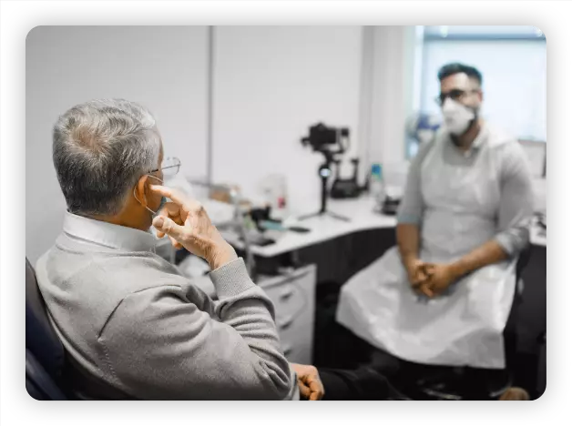 Man being consulted by a Hearing Aid Specialist