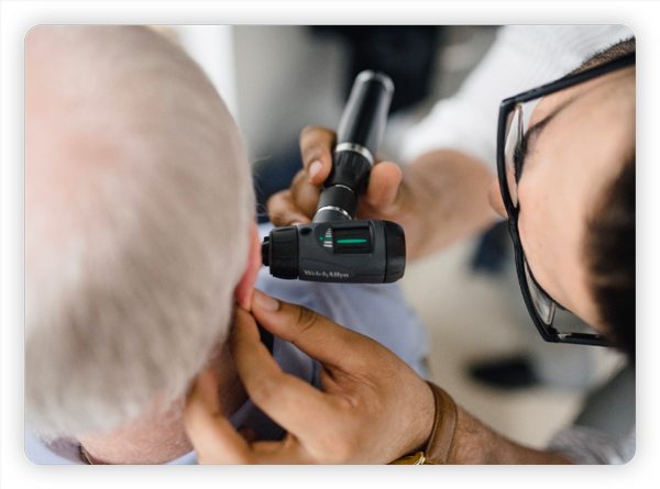 Audiologist checking hearing of a patient