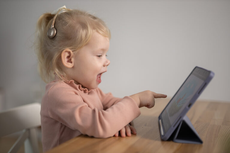 Deaf Child Girl With Cochlear Implant Studying To Hear Sounds -
