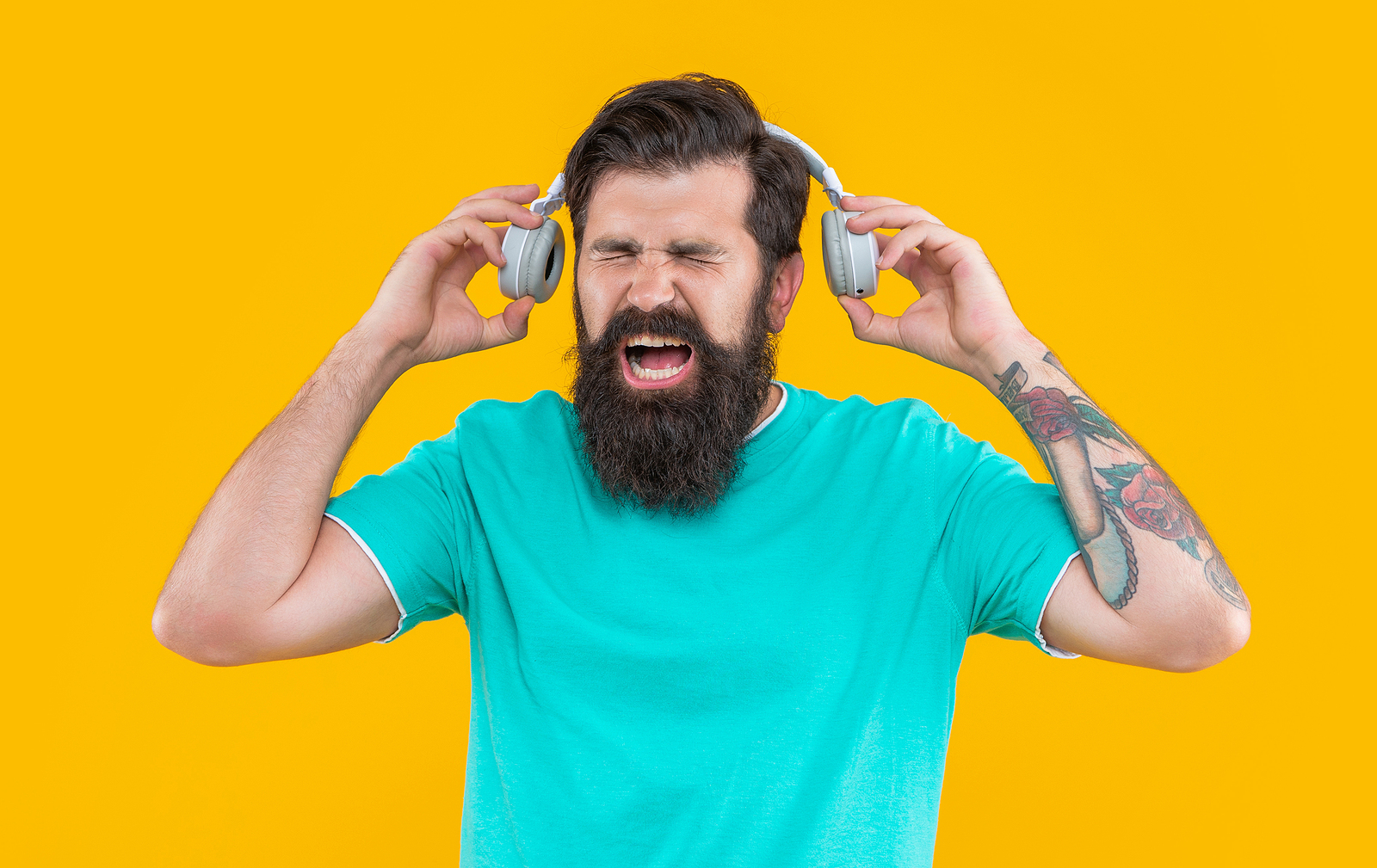 Annoyed Man Shout And Has Loud Music In Headphones Isolated On Y