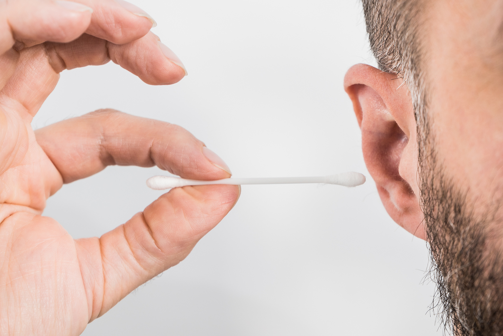 Man About To Clean His Ears Using Q-tip Cotton Swab. Hygiene Ess