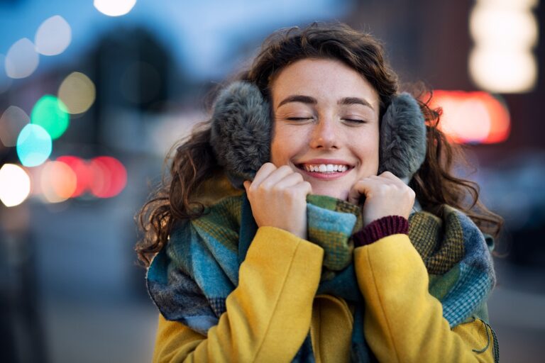 Ear wax removal - woman wearing winter clothe