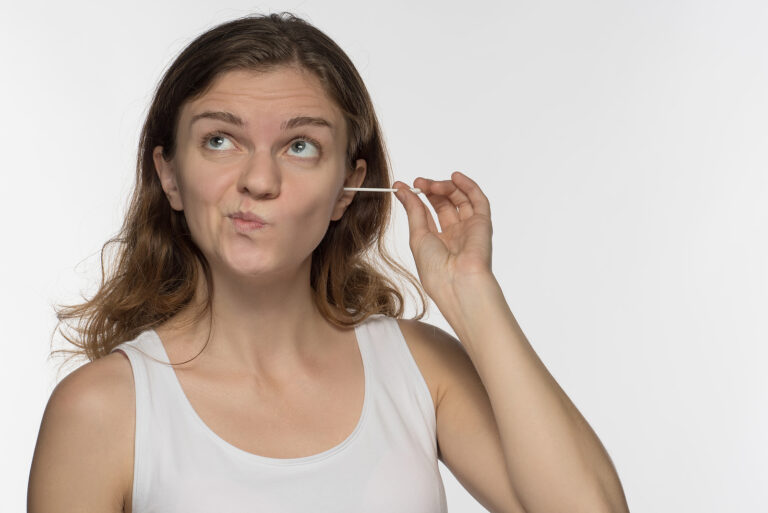 earwax removal - girl cleans the ears