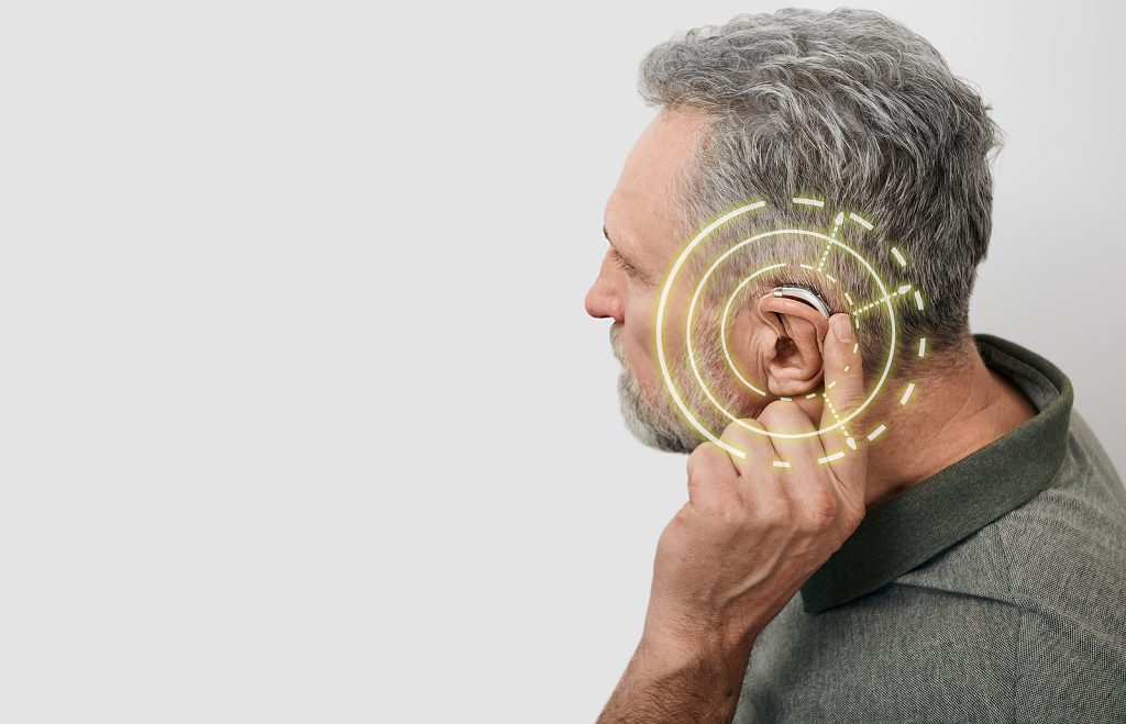 private hearing aids - Senior man can hear sounds with hearing aid