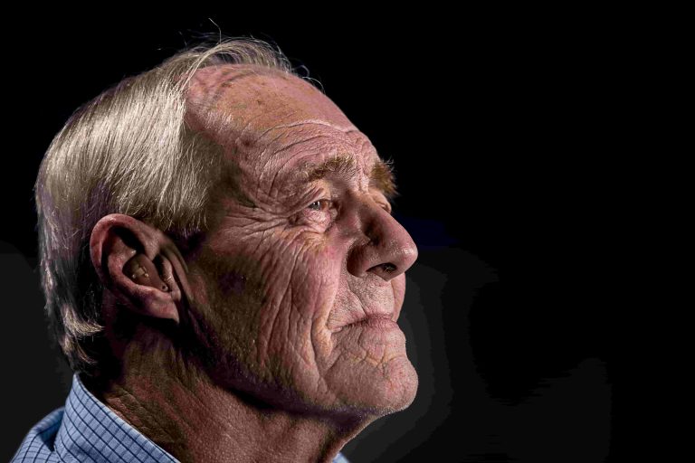private hearing aids - old man wearing hearing aid